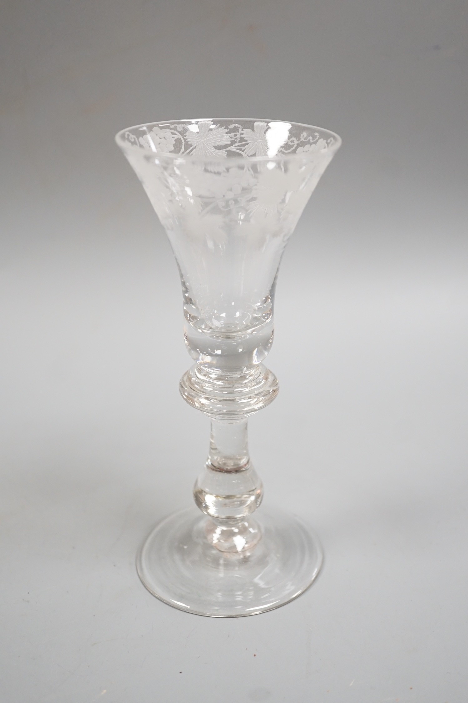 An engraved baluster stem wine glass, 17cm